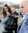  ?? AP ?? Serena Williams is escorted to a car on her arrival at Auckland Airport. —
