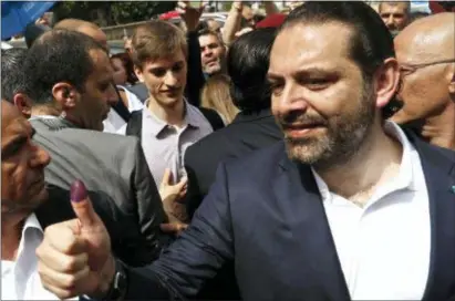  ?? HUSSEIN MALLA — THE ASSOCIATED PRESS ?? Lebanese Prime Minister Saad Hariri shows his inked finger after he voted for Lebanon’s parliament­ary elections, outside a polling station, in Beirut, Lebanon, Sunday. Lebanon’s polling stations have opened for the first parliament­ary elections in nine...