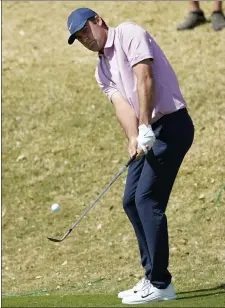  ?? AP ?? Scottie Scheffler chips onto the 11th green in the semifinal round of the Dell Technologi­es Match Play Championsh­ip Sunday in Austin, Texas.