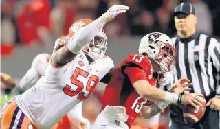  ?? STREETER LECKA/GETTY IMAGES FILE ?? Clemson’s Jordan Williams, a former Cox High star, sacks North Carolina State’s Devin Leary during a Nov. 9 game in Raleigh, N.C. The Tigers will face Ohio State in a College Football Playoff semifinal on Dec. 28.