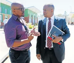  ??  ?? HEATED MEETING: Left, social developmen­t spokespers­on Mzukisi Solani speaks to economic developmen­t HOD Bongani Gxilishe, after he told staff not to enter the department’s offices for their own safety. Right, Nondumiso Mtuzula, of Nehawu, claims Gxilishe assaulted her during a heated meeting with staff in King William’s Town.