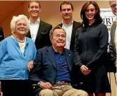  ??  ?? Heather Lind, right, claims George H W Bush, centre, ‘‘touched me from behind from his wheelchair’’.