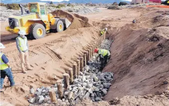  ?? SOURCE: SANTA FE CITY GOVERNMENT ?? This photo shows how rocks are used to shore up juniper posts to create an erosion control structure along the Arroyo de Los Chamisos.