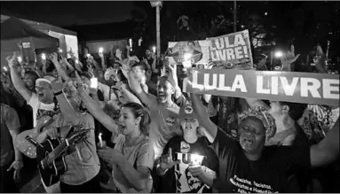  ??  ?? Supporters of Luiz Inacio Lula da Silva attend a vigil outside the Federal Police Superinten­dence in Curitiba, Brazil.(Photo: AFP)