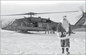  ??  ?? Santa Claus arriving in Napakiak, Alaska, on an Alaska National Guard UH-60 Black Hawk helicopter. The Guard brought its Operation Santa Claus to the western Alaska community.