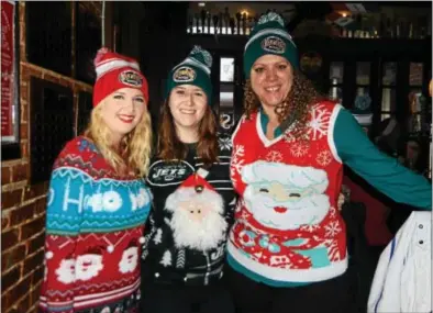  ?? NICHOLAS BUONANNO- NBUONANNO@TROYRECORD.COM ?? Three friends enjoy the 11th annual Ugly Sweater Pub Crawl in Saratoga Saturday afternoon, from left, Stephanie Pudlowski, Shannon McLellan and Meghann Daly.