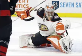  ?? KARL B DEBLAKER — THE ASSOCIATED PRESS ?? Ducks goaltender John Gibson gloves a shot for one of his 51saves against the Hurricanes during Saturday's game in Raleigh, N.C. The Ducks won their second in a row.