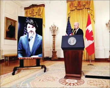  ?? AFP ?? Canadian Prime Minister Justin Trudeau (on screen) and US President Joe Biden and speak to the media after holding a virtual bilateral meeting in the East Room of the White House in Washington, DC on Tuesday.