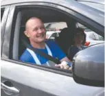  ?? STAFF PHOTO BY TIM BARBER ?? Maj. Tommy Bradford smiles as he passes Dade Elementary students on his way home to Trenton, Ga., on Wednesday morning.