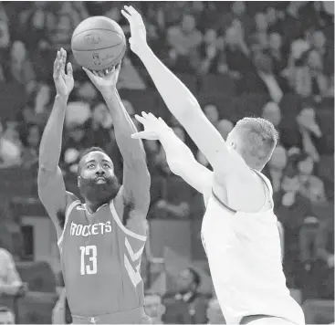  ?? Frank Franklin II / Associated Press ?? James Harden (13) shoots over New York’s Kristaps Porzingis during the first half Wednesday night at Madison Square Garden in New York. Harden finished with a season-high 31 points.