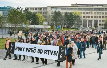  ?? PAVOL ZACHAR/TASR ?? No to takeover: People carry a “Hands off RTVS” banner as they take part in a protest Wednesday organized by the Slovakian opposition parties in Bratislava. A plan by Culture Minister Martina Šimkovicov­á to take over Slovakian public radio and television has been condemned by President Zuzana Caputová and others, including the European Commission.