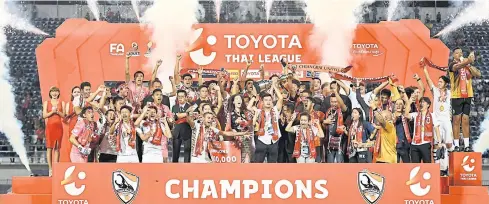  ??  ?? Chiang Rai United players and officials celebrate after winning the club’s first ever Thai League 1 title.