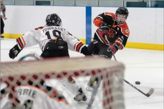  ?? NEWS PHOTO RYAN MCCRACKEN ?? Medicine Hat Hounds Black captain Ty Hynes fires a shot at Hounds Orange goaltender Gabriel Currie while Ashton Tumback defends during a South Central Alberta Hockey League U13 AA game on Friday at Hockey Hounds Rec Centre.