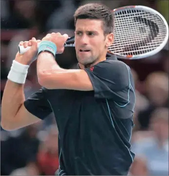 ?? GETTY IMAGES ?? TWO-FISTED PUNCH: Serbian Novak Djokovic in action in his quarter-final match against Stanislas Wawrinka of Switzerlan­d at the Paribas Masters in Paris yesterday.