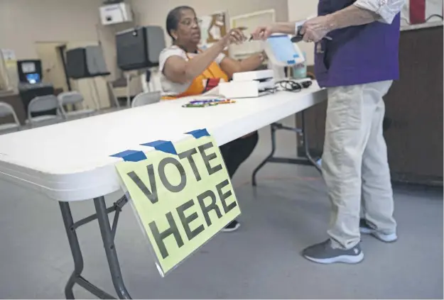  ?? ?? A voter checks in at polling location during the South Carolina Democratic Primary
