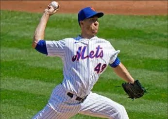  ?? AP Photo/Kathy Willens ?? New York Mets starting pitcher Jacob deGrom winds up during the second inning of a baseball game against the Philadelph­ia Phillies, on Sunday in New York.