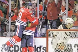  ?? NAM Y. HUH / AP ?? Blackhawks left wing Brandon Saad (right) celebrates his second-period goal with center Jonathan Toews during Wednesday night’s 5-2 victory over the Ducks in Game 6 of the Western Conference finals in Chicago. Game 7 is Saturday night in Anaheim.