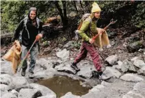  ?? Tracy Barbutes/Special to The Chronicle ?? Volunteers hike up the Yosemite Falls trail during the Yosemite Facelift cleanup event in September.