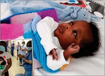  ??  ?? BaTTLer: Emmanuel in hospital and, left, being carried by his mother Evelyn as staff clap them out of hospital after his recovery