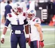  ?? Abbie Parr / Getty Images ?? The Patriots’ Julian Edelman, right, talks with Cam Newton before their Sept. 20 game against the Seahawks.