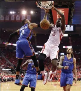  ?? DAVID J. PHILLIP — THE ASSOCIATED PRESS ?? Houston Rockets’ Clint Capela (15) dunks as the Oklahoma City Thunder’s Russell Westbrook, left, defends during the second half in Game 5 of an NBA first-round playoff series, Tuesday in Houston. The Rockets won 105-99 to win the best-of seven series...