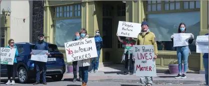  ?? Photo by Christy Riordan ?? Protestors outside the direct provision centre in Cahersivee­n calling for its closure following an outbreak of Covid-19 at the centre.