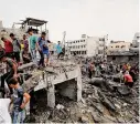  ?? Ali Mahmoud/Associated Press ?? Palestinia­ns inspect the rubble of a destroyed building Friday after an Israeli airstrike in Deir al Balah, Gaza Strip.