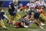  ?? JEFF SINER - THE ASSOCIATED PRESS ?? Clemson linebacker Baylon Spector, bottom center and Notre Dame running back Kyren Williams, right, scramble to grab a fumble during the Atlantic Coast Conference championsh­ip NCAA college football game, Saturday, Dec. 19, 2020, in Charlotte, N.C. Notre Dame recovered the ball.