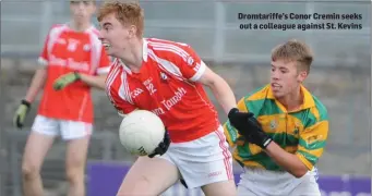  ??  ?? Dromtariff­e’s Conor Cremin seeks out a colleague against St. Kevins