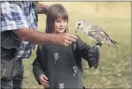  ?? TSVANGIRAY­I MUKWAZHI — THE ASSOCIATED PRESS ?? A child interacts with a bird at the bird sanctuary, Kuimba Shiri.