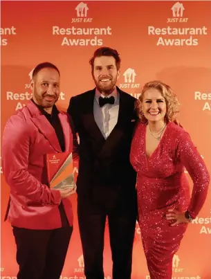  ?? ?? ‘SHOCKED AND SURPRISED’: Chris’s Fish and Chips owners Strad and Gina Kyriacou with host Joel Dommett at the Just Eat Restaurant Awards