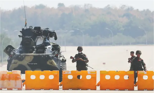  ?? Reuters ?? Soldiers staff a military checkpoint on the way to the congress compound in Naypyitaw, the capital of Myanmar, after a military coup on Monday.