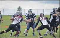  ?? DAVE STEWART/TC MEDIA ?? UNB Saint John Seawolves’ Anders Blizzard tries to get through the Holland Hurricanes defence, Jake Rushford, left, and Felix Derelle, during Atlantic Football League action at UPEI on Saturday