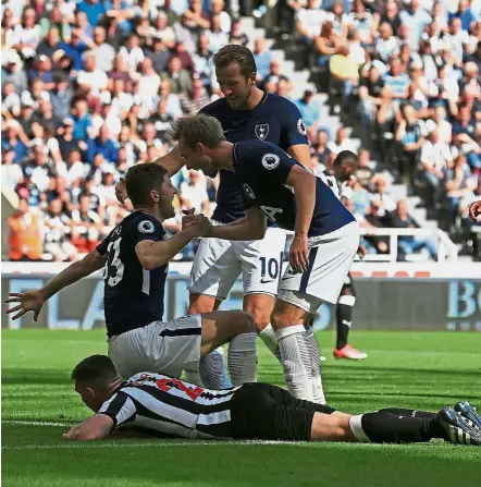  ?? — AFP ?? Well done: Tottenham Hotspur’s Christian Eriksen (centre) congratula­tes Ben Davies after he scored their second goal during the English Premier League match against Newcastle on Sunday.