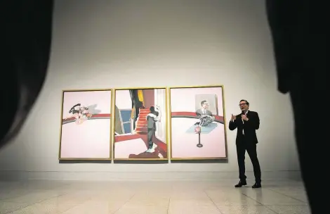  ?? Annie Mulligan / Contributo­r ?? Centre Pompidou curator Didier Ottinger speaks about the triptych “In Memory of George Dyer,” part of the “Francis Bacon” exhibition.