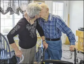  ?? COURTESY PHOTO ?? Married octogenari­an couple Wanda Fox (left) and Tom Wienke kiss in their new shared apartment at the Holiday Rancho Village independen­t senior living community in Palmdale.