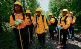  ?? GEORGE WALKER IV/ASSOCIATED PRESS ?? Wildland firefighte­r students from Alabama A&M and Tuskegee universiti­es trained in June in Hazel Green, Ala.