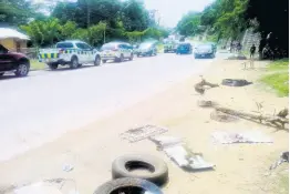  ?? PHOTO BY HOPETON BUCKNOR ?? Debris from a dismantled roadblock lies at the side of a thoroughfa­re in the vicinity of Elgin Town, Hanover, on Tuesday. Protesters were demonstrat­ing against the police shooting of a 28-year-old resident.