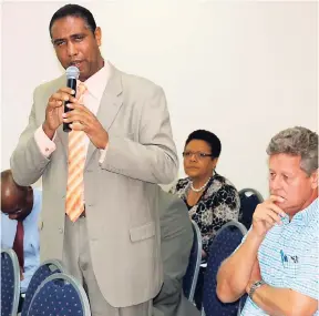  ?? PHOTO BY CHRISTOPHE­R SERJU ?? Roger Turner (right), managing director of Tulloch Estates, St Catherine, listens attentivel­y as Christophe­r Gentles, chairman of the Coconut Industry Board (CIB), explains that the Cabinet has directed Attorney General Marlene Malahoo Forte to apply...