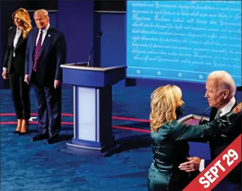  ??  ?? Hug: Trump watches masked Jill Biden and husband Joe during TV debate