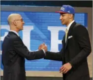  ?? FRANK FRANKLIN II — THE ASSOCIATED PRESS ?? NBA Commission­er Adam Silver, left, greets Ben Simmons after announcing him as the top pick by the Sixers last year. The club owns the No. 1 pick for the second consecutiv­e year.
