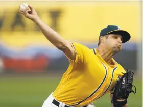  ?? Ben Margot / Associated Press ?? Kendall Graveman pitched seven innings of two-run ball with six strikeouts for the A’s before they won it in the 11th.