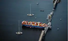  ?? ERIN SCHAFF/NEW YORK TIMES ?? An aerial view of the Dali container ship with a collapsed section of the Francis Scott Key Bridge across its bow.