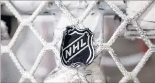  ?? CP PHOTO ?? In this file photo, the NHL logo is seen on a goal at a Nashville Predators practice rink in Nashville, Tenn.