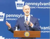  ?? JOE HERMITT/AP ?? Gov. TomWolf said Thursday that the state will be“scrambling”to find ways to fill a coronaviru­s-driven budget deficit that has been estimated at $5 billion over two years. The state, he said, has to work on getting itself back on its own feet. He said he would work to“shore up”finances whenever possible.