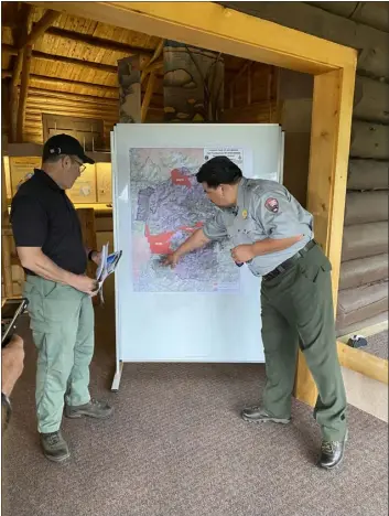  ?? PROVIDED BY NPS.ORG ?? National Park Service director Chuck Sams, right, is being briefed by Rocky Mountain National Park fire management officer Mike Lewelling recently regarding the role fuel mitigation efforts in advance of the East Troublesom­e fire of 2020.