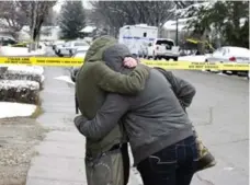  ?? LARRY MACDOUGAL/THE CANADIAN PRESS ?? Two friends console each other on Wednesday near the crime scene.