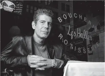  ?? Associated Press file photo ?? ■ Anthony Bourdain, the owner and chef of Les Halles restaurant, sits at one of the tables in New York. On Friday, Bourdain was found dead in his hotel room in France.