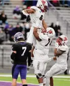  ?? Julie Vennitt Botos/Associated Press ?? North Central’s DeAngelo Hardy celebrates a touchdown against Mount Union with teammates Jarod Thornton (74) and Matt Robinson in the second quarter in the semifinals of the NCAA Div. III playoffs in 2021.