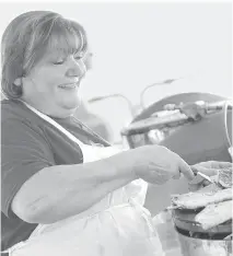  ?? JULIE OLIVER ?? Yvette Gharib, happily cooks up tasty saj bread lathered in garlic and thyme and served with cucumbers for Ottawa’s Lebanese Festival. Multicultu­ralism goes beyond food and ethnic festivals.